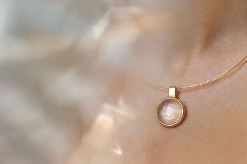 Image of "Rays of the Sun..." goldplated silver pendant with rock crystal  · RADII SOLIS... ·