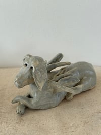 Image 5 of Winged Creatures: Green dog at rest