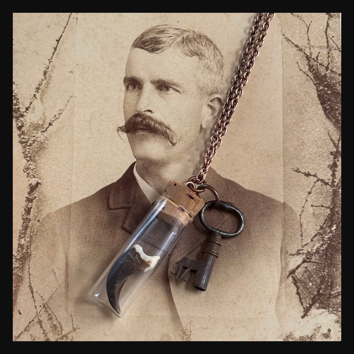Coyote Claw in vintage watch parts vial with barrel key necklace