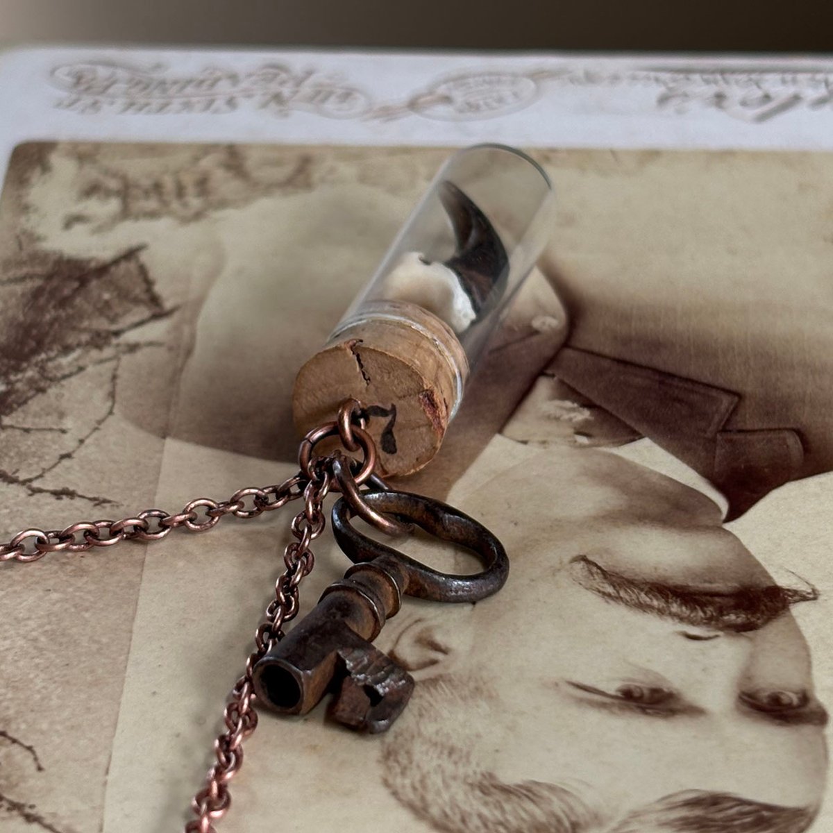 Coyote Claw in vintage watch parts vial with barrel key necklace