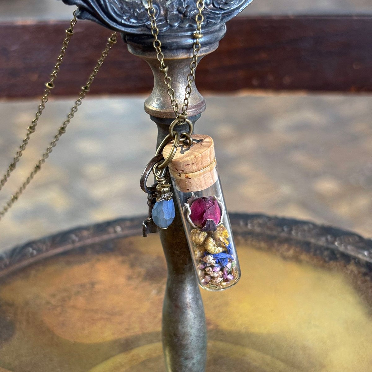 Dried Floral in vintage watch parts vial with barrel key necklace
