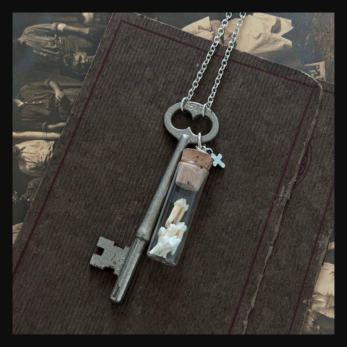 Opossum teeth in vintage watch parts vial with skeleton key necklace