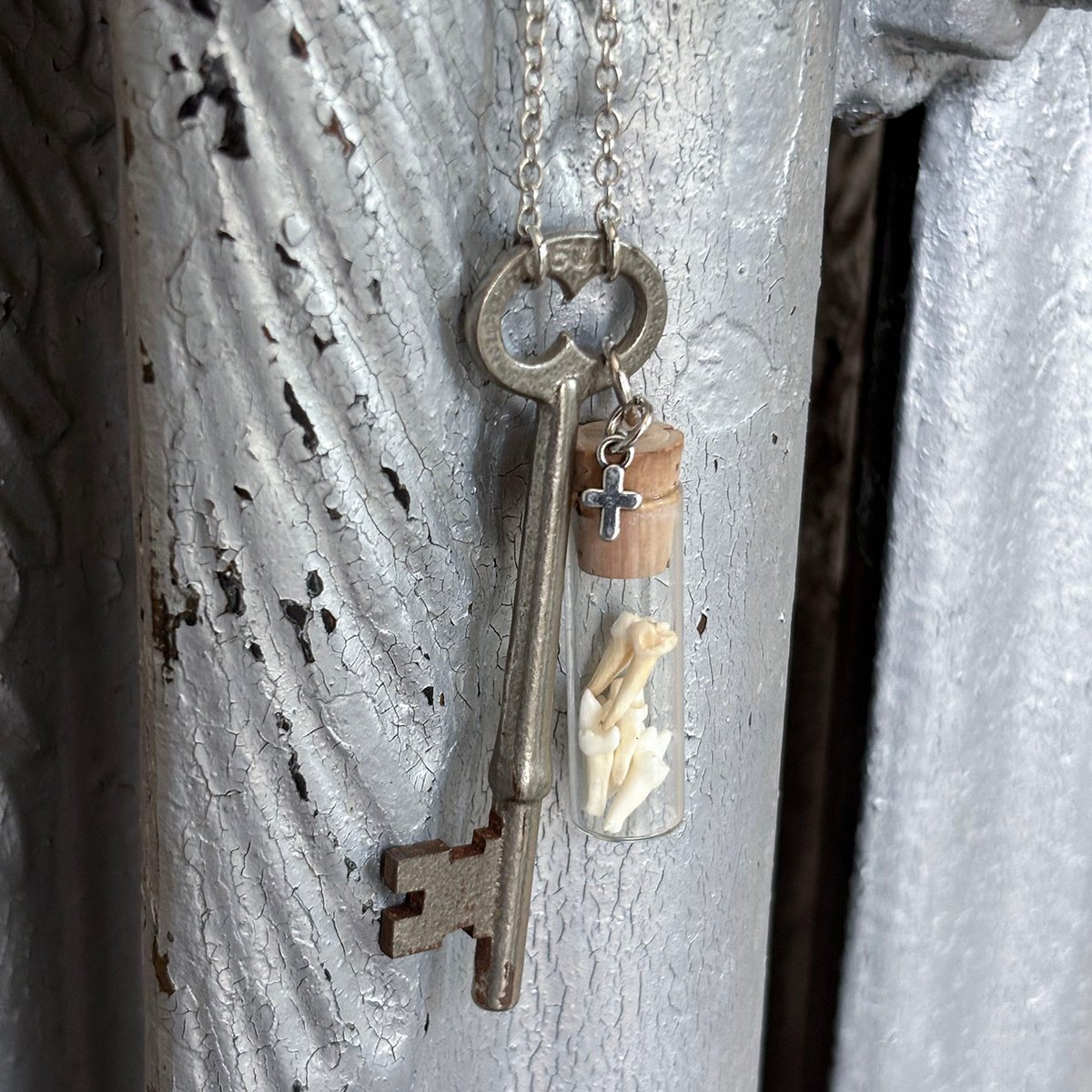 Opossum teeth in vintage watch parts vial with skeleton key necklace