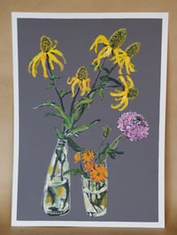 Rudbeckia, scabiosa and marigold in vases