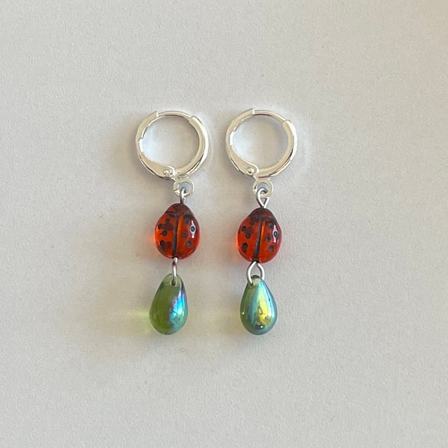 red ladybug and green teardrop huggie hoop earrings