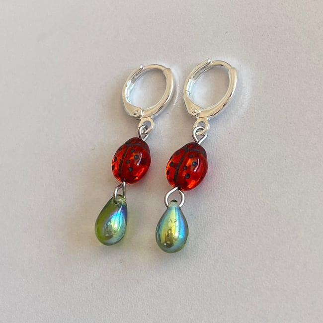 red ladybug and green teardrop huggie hoop earrings