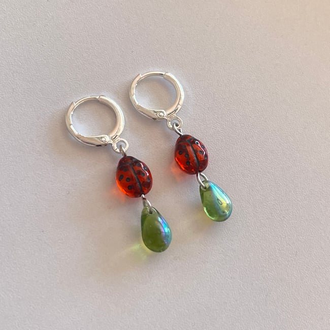 red ladybug and green teardrop huggie hoop earrings