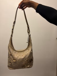 Image 1 of 2012 Coach monogram hobo shoulder bag with a beige and gold floral appliqué design