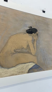 Image 2 of Sitting on the edge of the bed