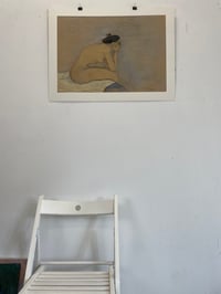 Image 3 of Sitting on the edge of the bed