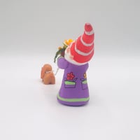 Image 2 of Stewart the gnome with orange flowers and Sage the brown spaniel puppy