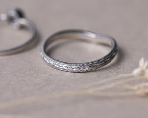 Image of Platinum 2mm flat court ‘Olive leaf’ and milled edge engraved wishbone ring