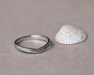 Image of Platinum 2mm flat court ‘Olive leaf’ and milled edge engraved wishbone ring