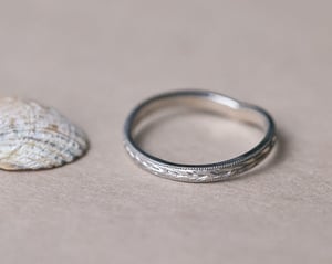 Image of Platinum 2mm flat court ‘Olive leaf’ and milled edge engraved wishbone ring