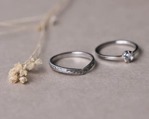 Image of Platinum 2mm flat court ‘Olive leaf’ and milled edge engraved wishbone ring