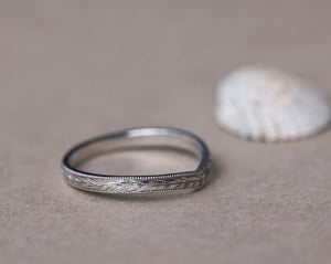 Image of Platinum 2mm flat court ‘Olive leaf’ and milled edge engraved wishbone ring