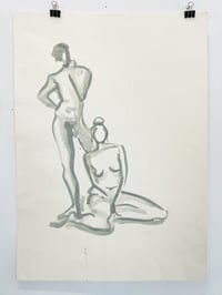 Image 1 of Man standing, woman sitting in front