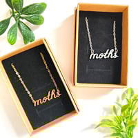 Image 1 of 'moths' Cursive Text Steel Necklace