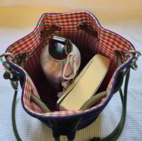 Image 3 of Padded bucket bag with an adjustable crossbody or shoulder strap.