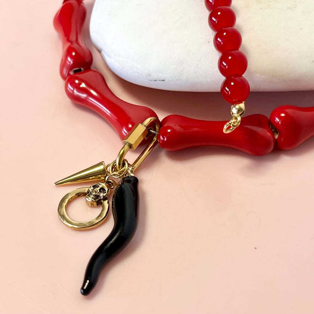 Image of Red glass bead and bone necklace with wiggly tusk