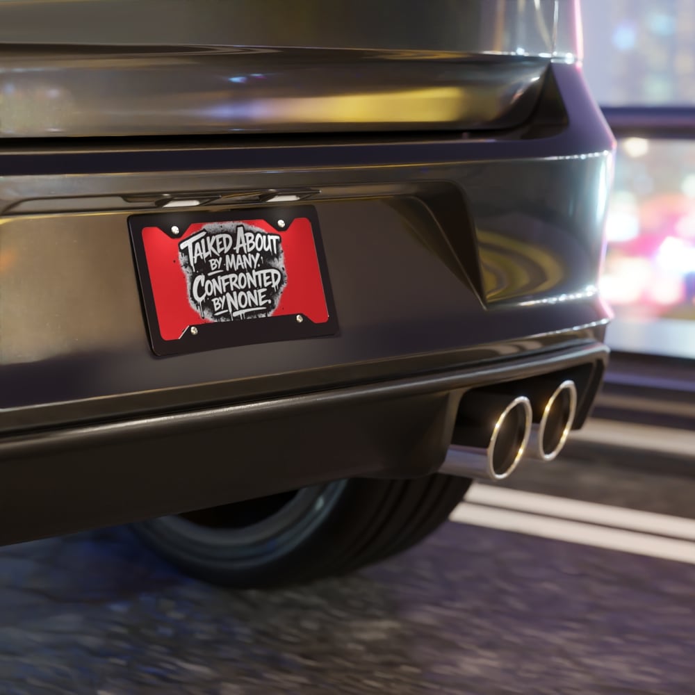 Image of Vanity Plate - 'Talked About by Many, Confronted by None' Red License Plate