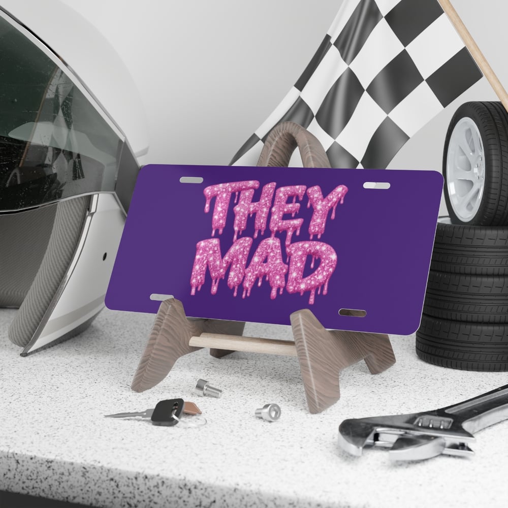 Image of They Mad Vanity Plate — Pink Drip Glitter Text on Purple License Plate
