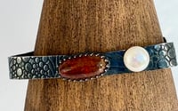 Image 1 of Blackened textured silver bangle with an amber gemstone and a freshwater pearl
