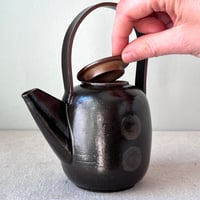 Image 4 of a black button teapot