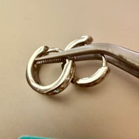 Image 1 of Moissanite Channel-Set Huggie Earrings | 925 Sterling Silver | 0.39CTW VVS D | 11.9mm