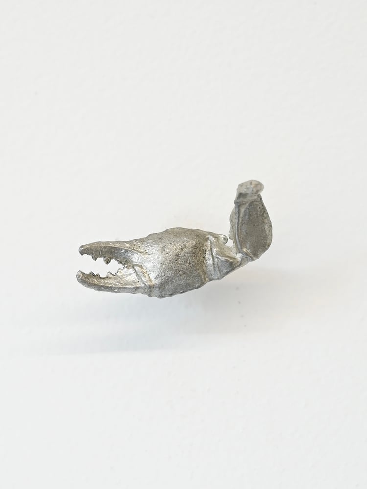 Image of Beth Arnold, Turning the Clay, 2026,  1.5cm x 4.5cm x 1.5 cm   Reclaimed pewter, rare earth magnet 