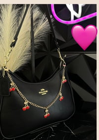 Black leather coach with charm