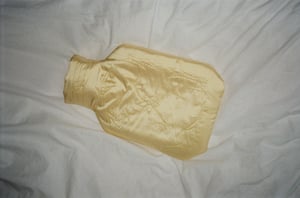 Image of Silk covered hot water bottle, butter with stars