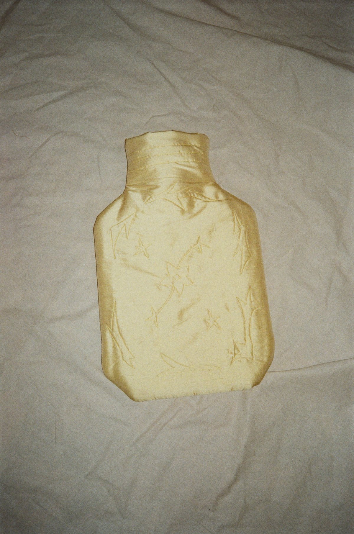 Image of Silk covered hot water bottle, butter with stars