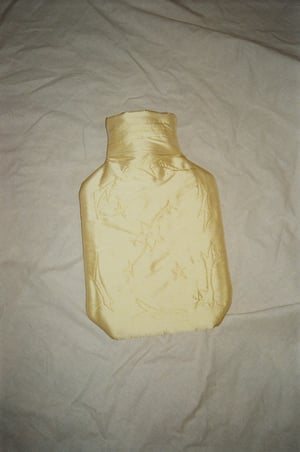 Image of Silk covered hot water bottle, butter with stars