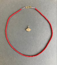 Image 2 of Brass Averting Eye on a coral strand 