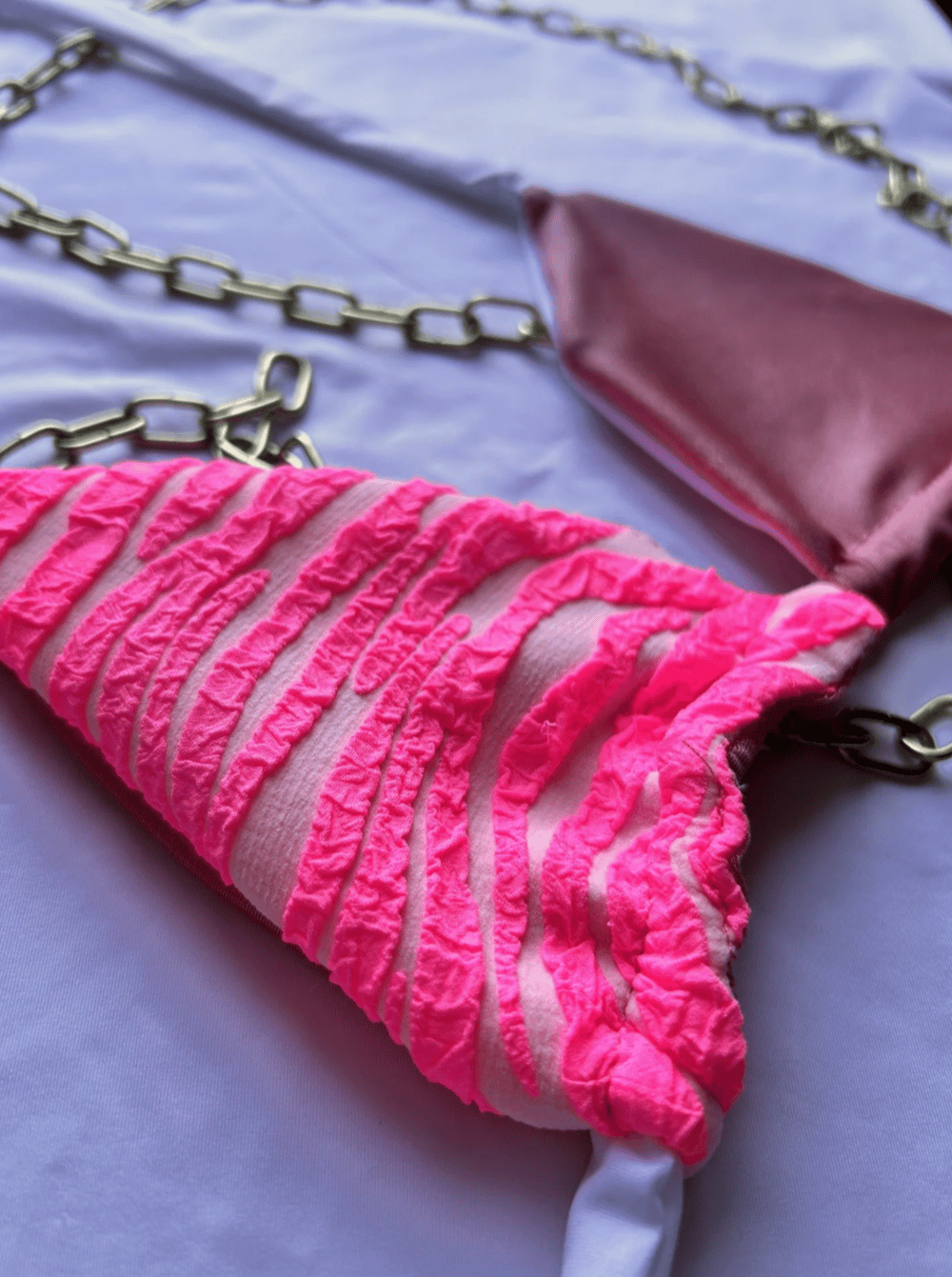 Image of the fuchsia wild pink zebra & glossy pink reversible bikini top