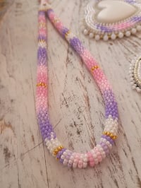Image 1 of White, pink and purple wristlet 
