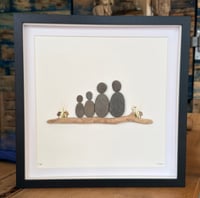 Pebble family with pebble birds on driftwood