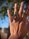 Geometric design with coral and onyx ring 