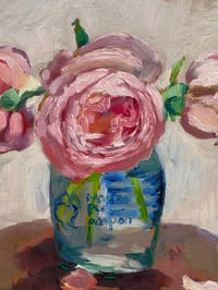 Image 2 of Pink roses in mustard jar on table