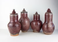 Image 1 of Four stoneware red vases