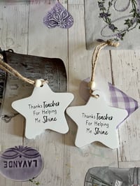 Teacher hanging star 