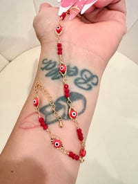 Image 1 of Red eyes gold laminated anklet 