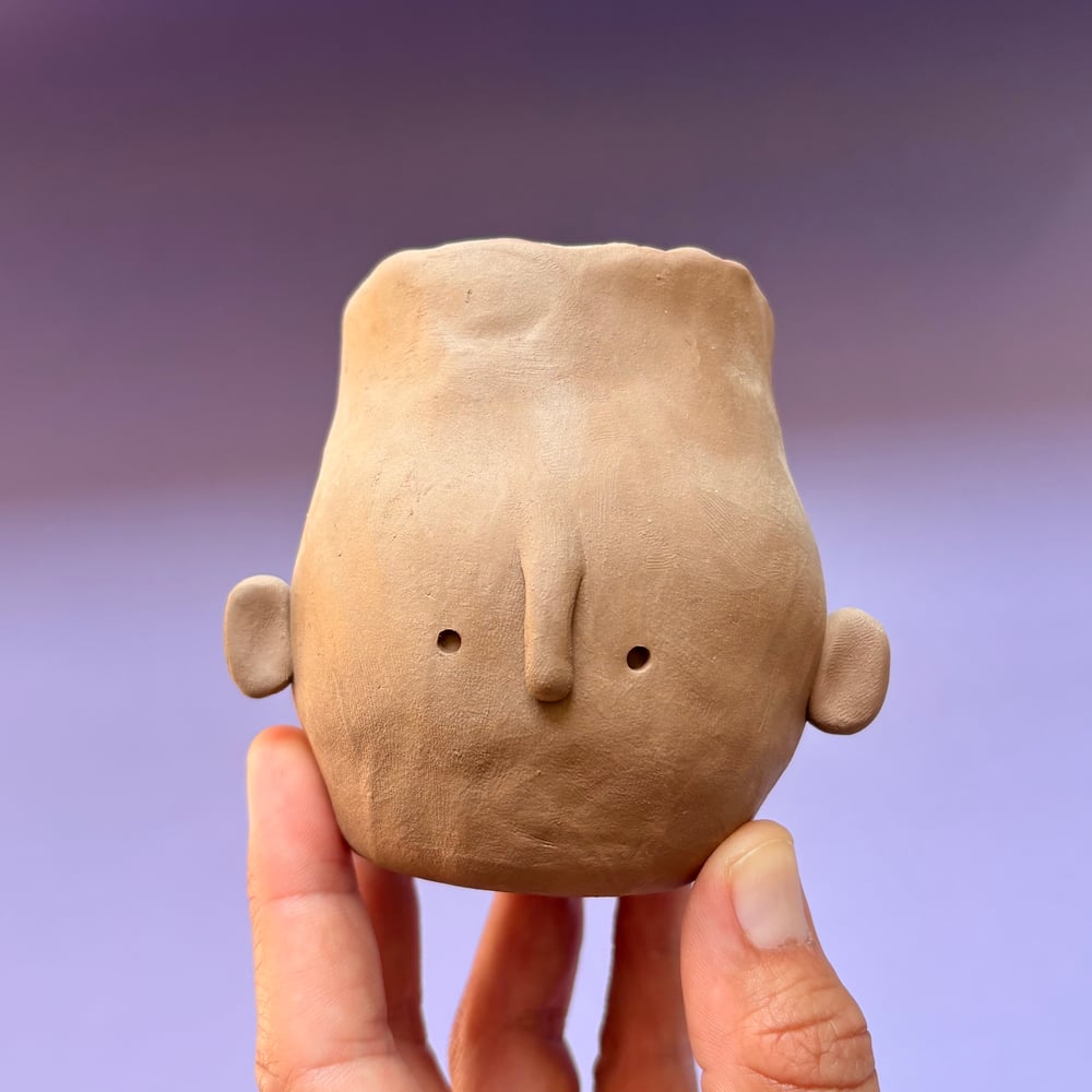 Image of Egg head face pot