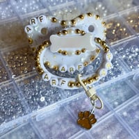 Image 1 of Gold Puppy Bone Adult Pacifier