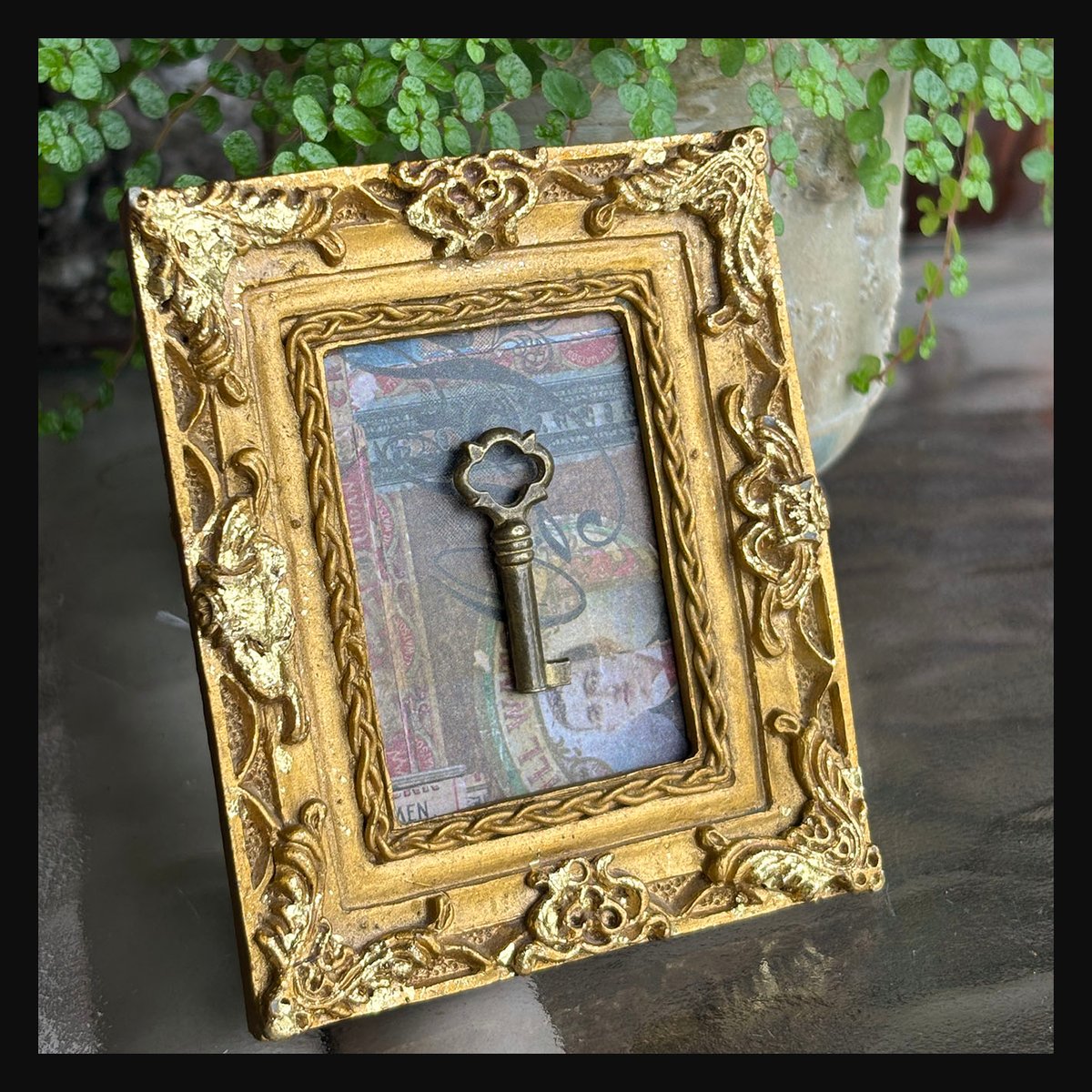 Tiny Brass Barrel Key in Ornate Gold Vintage frame