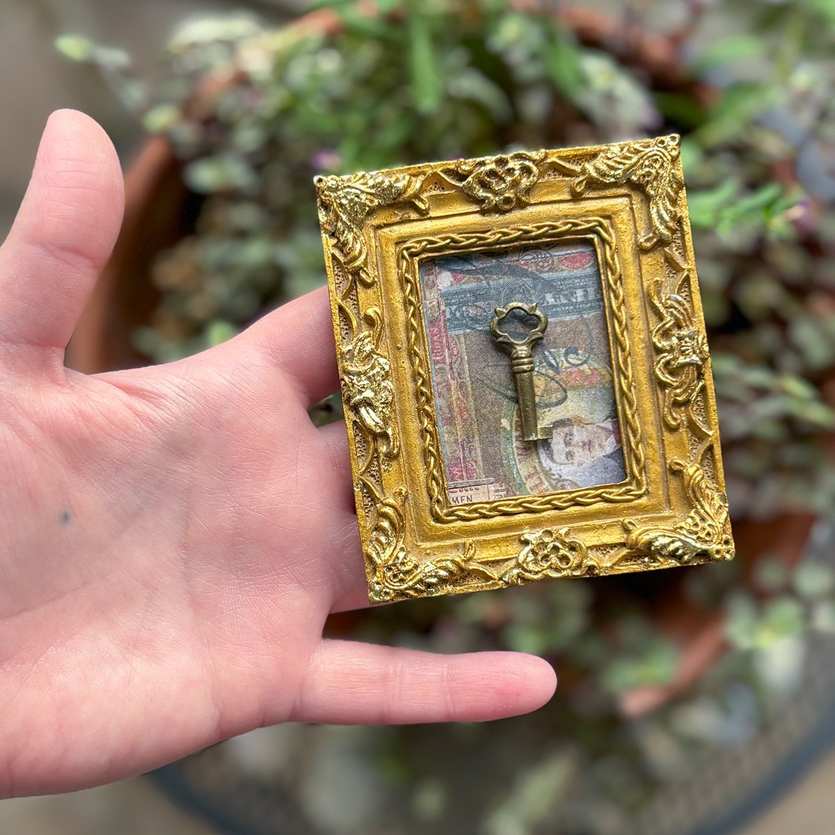 Tiny Brass Barrel Key in Ornate Gold Vintage frame