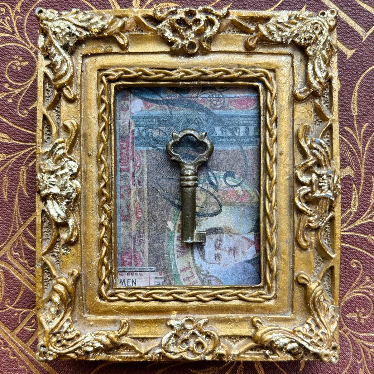 Tiny Brass Barrel Key in Ornate Gold Vintage frame