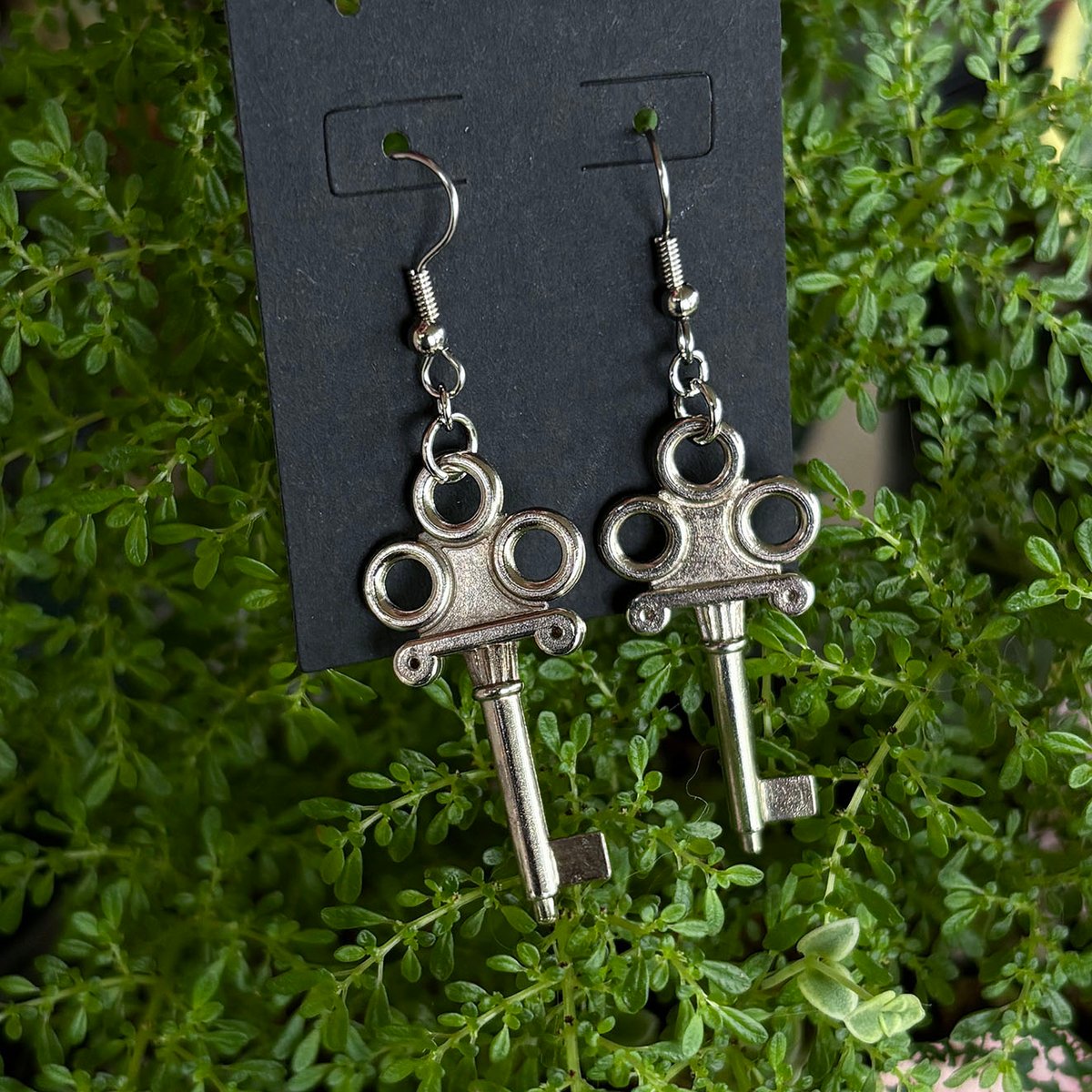 Ornate silver jewelry box key earrings