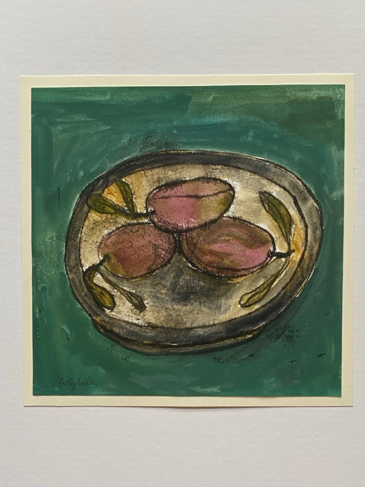 Image of Plums in a dish on green cloth